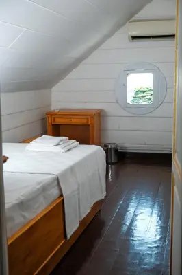 a small bedroom with a bed and a window at Laden Palas Prince's Island Historical Mansion in Adalar