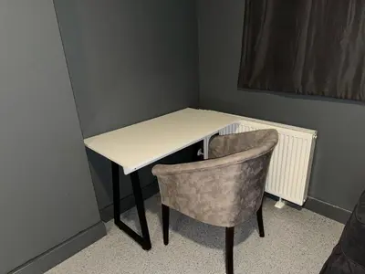 a desk with a chair and a white desk with at Aderans Hotel in Istanbul