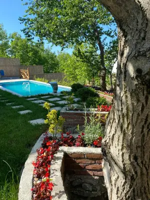 a garden with flowers and a swimming pool at Nefes Vılla Sapanca in Sakarya