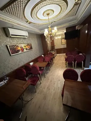 a dining room with tables and chairs and a ceiling at Sahra Airport Hotel in Istanbul