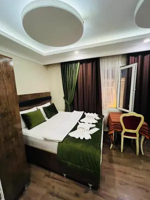 a bedroom with a large bed and a chair at Bona apart in Istanbul