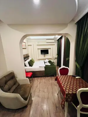 a living room with a bed and a couch and a table at Bona apart in Istanbul