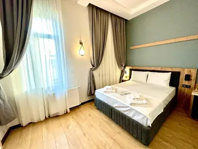a bedroom with a bed and a large window at Newalla Hotel Old City in Istanbul