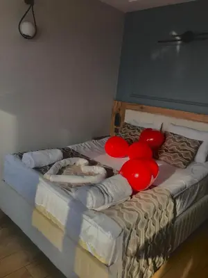 a bed with red balloons and pillows on it at Newalla Hotel Old City in Istanbul