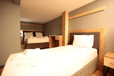 a hotel room with two beds with white sheets at Newalla Hotel Old City in Istanbul