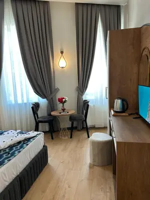 a hotel room with a bed and a table with chairs at Newalla Hotel Old City in Istanbul