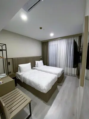 a hotel room with two beds and a table at Joy Taksim in Istanbul