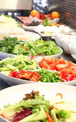 a buffet with many plates of vegetables in bowls at Şişli Luxury K Suites Hotel in Istanbul