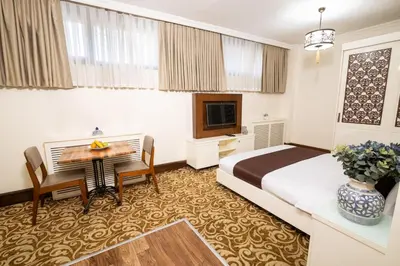 a hotel room with a bed and a desk at Şişli Luxury K Suites Hotel in Istanbul