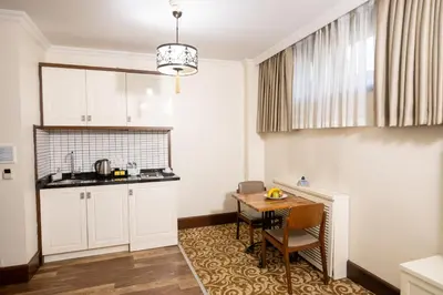 a kitchen with a table and a dining room at Şişli Luxury K Suites Hotel in Istanbul