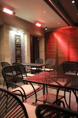 a dining room with tables and chairs and a clock at Şişli Luxury K Suites Hotel in Istanbul
