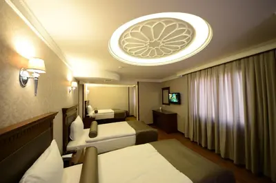 a hotel room with two beds and a large ceiling at Grand Bazaar Hotel in Istanbul