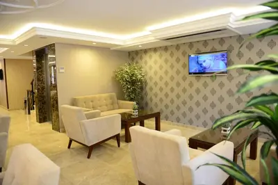 a waiting room with a couch and a tv on a wall at Grand Bazaar Hotel in Istanbul