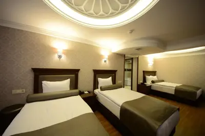 a hotel room with two beds and a round ceiling at Grand Bazaar Hotel in Istanbul