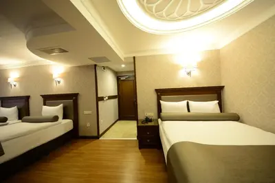 a hotel room with two beds and a round ceiling at Grand Bazaar Hotel in Istanbul