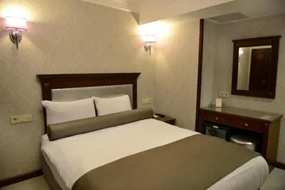 a hotel room with a large bed and a mirror at Grand Bazaar Hotel in Istanbul