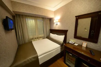 a hotel room with a bed and a mirror at Grand Bazaar Hotel in Istanbul
