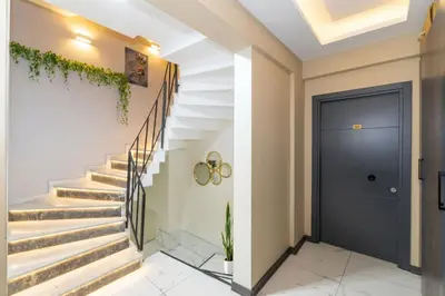 a hallway with stairs and a blue door at hotel La Vitrine in Istanbul