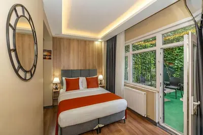 a bedroom with a bed and a large window at hotel La Vitrine in Istanbul