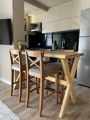 a kitchen with a wooden table and chairs at Myfair apartment in Istanbul