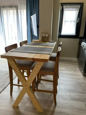 a wooden table with chairs and a dining room at Myfair apartment in Istanbul