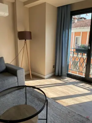 a living room with a couch and a glass table at Myfair apartment in Istanbul