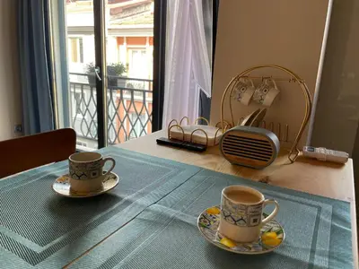 two cups of coffee on a table in front of a window at Myfair apartment in Istanbul