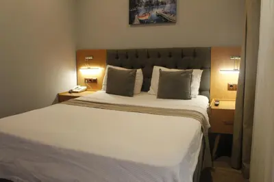 a bedroom with a large bed with two lamps and a phone at Ada Life Hotel in Istanbul
