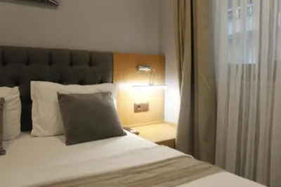 a bed with a headboard and a lamp in a room at Ada Life Hotel in Istanbul