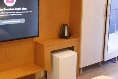a room with a tv and a small refrigerator at Ada Life Hotel in Istanbul