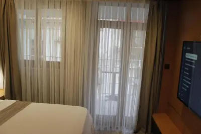 a bedroom with a bed and a window with curtains at Ada Life Hotel in Istanbul