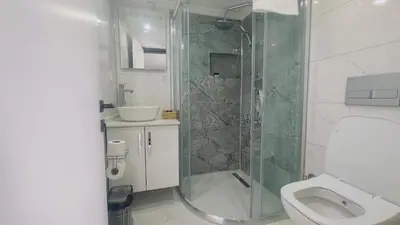 a bathroom with a shower and a toilet and a sink at La Mer Old City Hotel in Istanbul