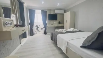 a hotel room with two beds and a kitchen at La Mer Old City Hotel in Istanbul