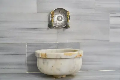 a bowl and a faucet on a wall at Shishly Palace Hotel in Istanbul