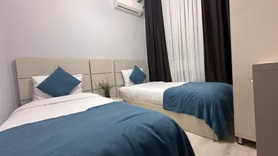 two beds in a room with blue and white at Overland Residence in Istanbul
