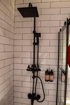 a bathroom with a shower with a rack with alcohol bottles at Alness Residence in Istanbul