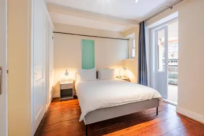 a bedroom with a bed and a large window at Homie Suites - Historical Apartments in the center of Beşiktaş in Istanbul
