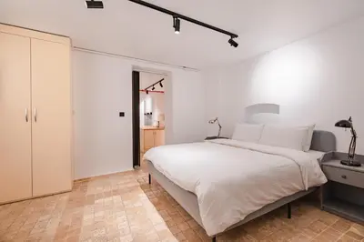 a white bedroom with a large bed and a closet at Homie Suites - Modern Apartments Nearby Istıklal Street & Galata Tower in Istanbul