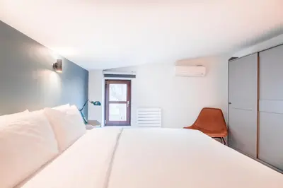 a bedroom with a large white bed and a window at Homie Suites - Modern Apartments Nearby Istıklal Street & Galata Tower in Istanbul