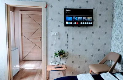 a room with a bed and a television on the wall at Stylish apartment in Istanbul