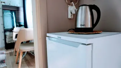 a tea kettle sitting on top of a refrigerator at Stylish apartment in Istanbul