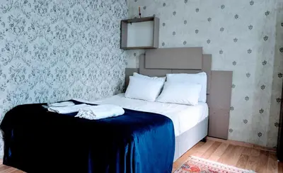 a bed with two towels on it in a bedroom at Stylish apartment in Istanbul