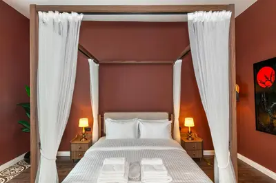 a bedroom with a canopy bed with white curtains at CLK Suites Hotel in Istanbul