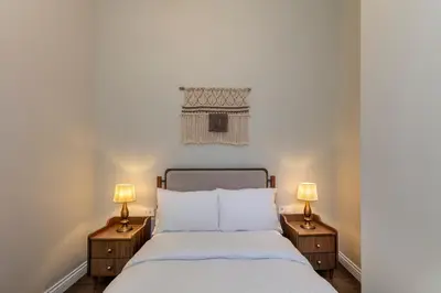 a bedroom with a white bed with two lamps at CLK Suites Hotel in Istanbul