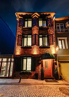 a brick building with a red door on a street at CLK Suites Hotel in Istanbul