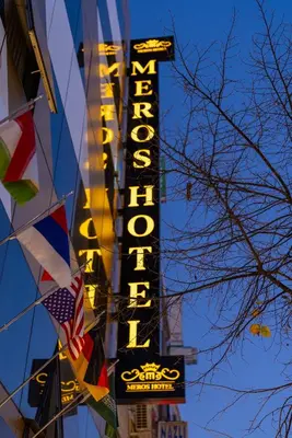a neon sign for a building with an american flag at Meros Hotel in Istanbul