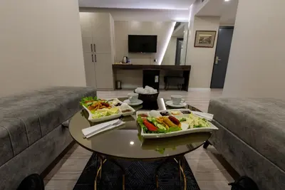 two dishes of food on a table in a living room at Meros Hotel in Istanbul