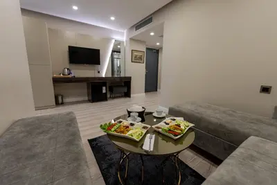 a living room with a couch and a table with food on it at Meros Hotel in Istanbul
