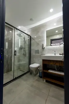 a bathroom with a shower and a toilet and a sink at Meros Hotel in Istanbul