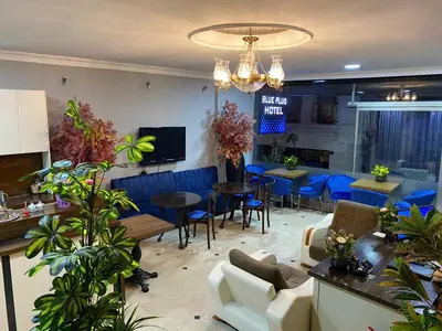 a living room with blue chairs and tables at BLUE PLUS HOTEL in Istanbul